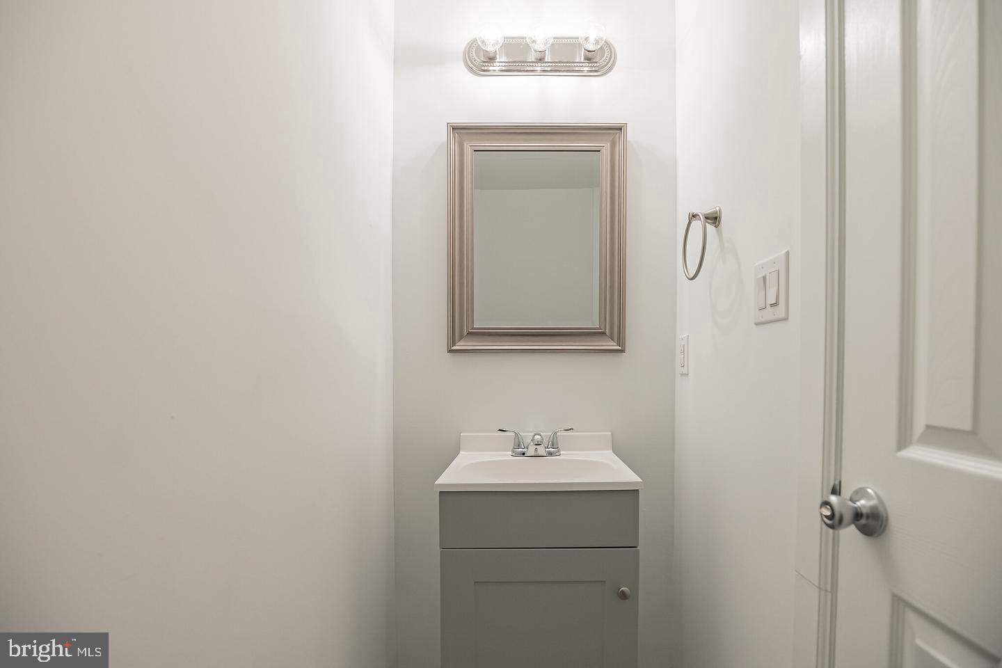 2630 Ridge Avenue, Unit 1 Philadelphia, PA 19121 - Photo 12 of 13 a bathroom with a sink a mirror and vanity