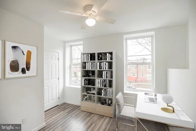 a workspace with furniture window and wooden floor