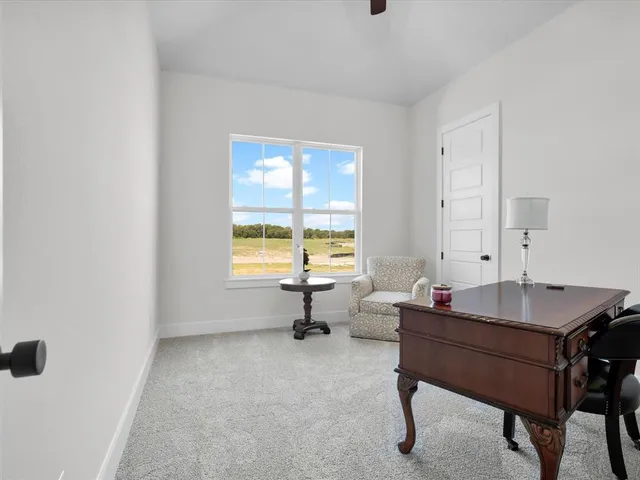 a reading room with wooden floor and furniture