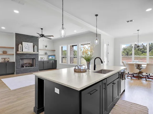 a kitchen with sink refrigerator and stove