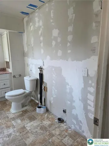 a bathroom with a toilet and a shower