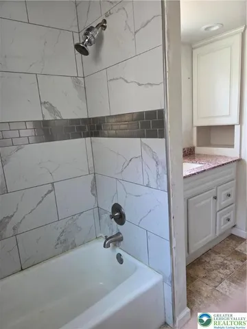 a bathroom with a bathtub and shower