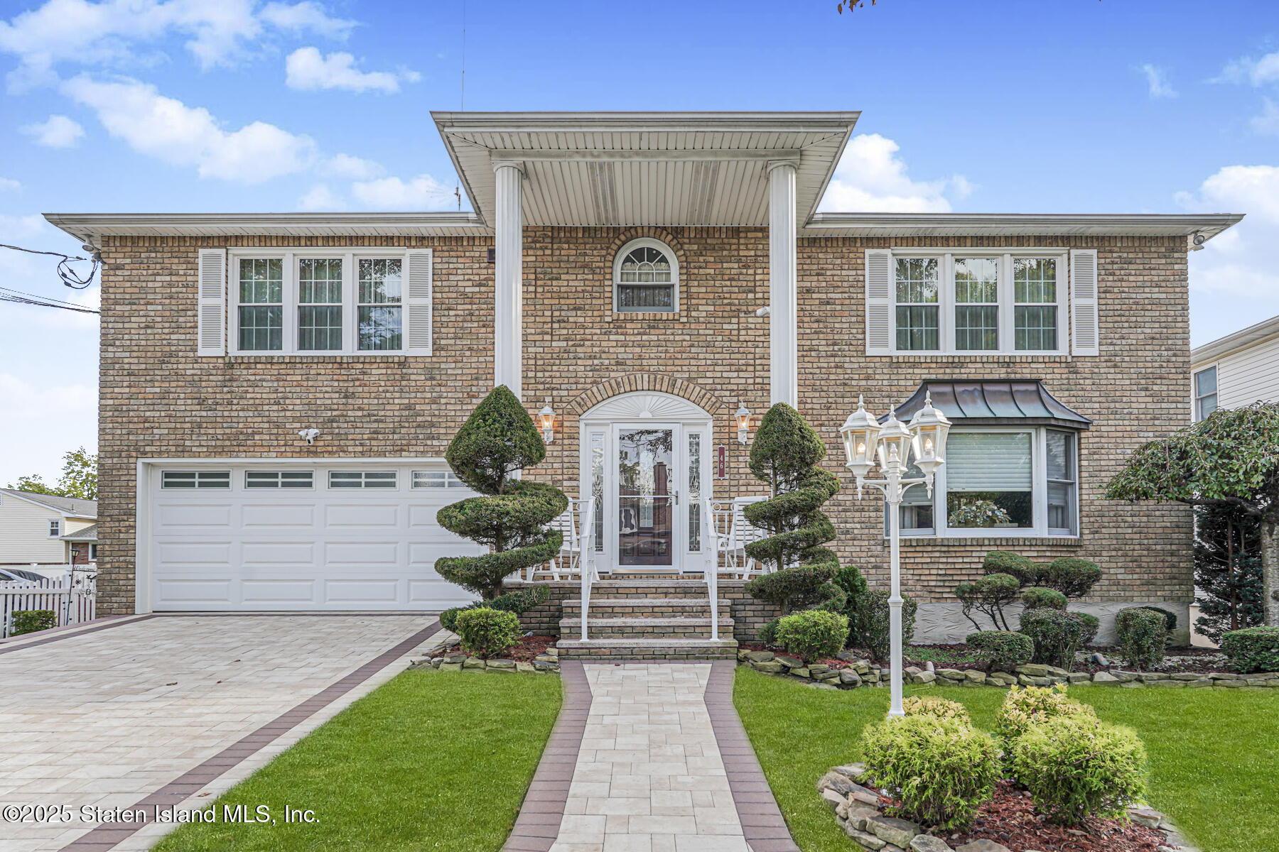 a front view of a house with garden