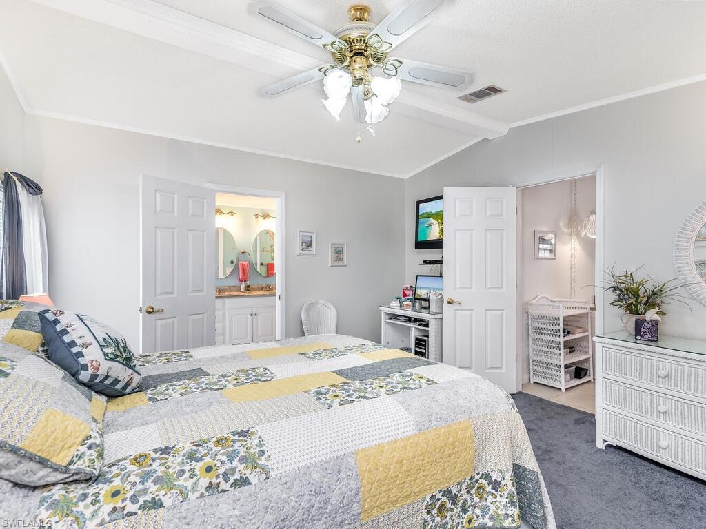 114 Audubon Road Naples, FL 34114 - Photo 16 of 34 a bedroom with a bed and ceiling fan