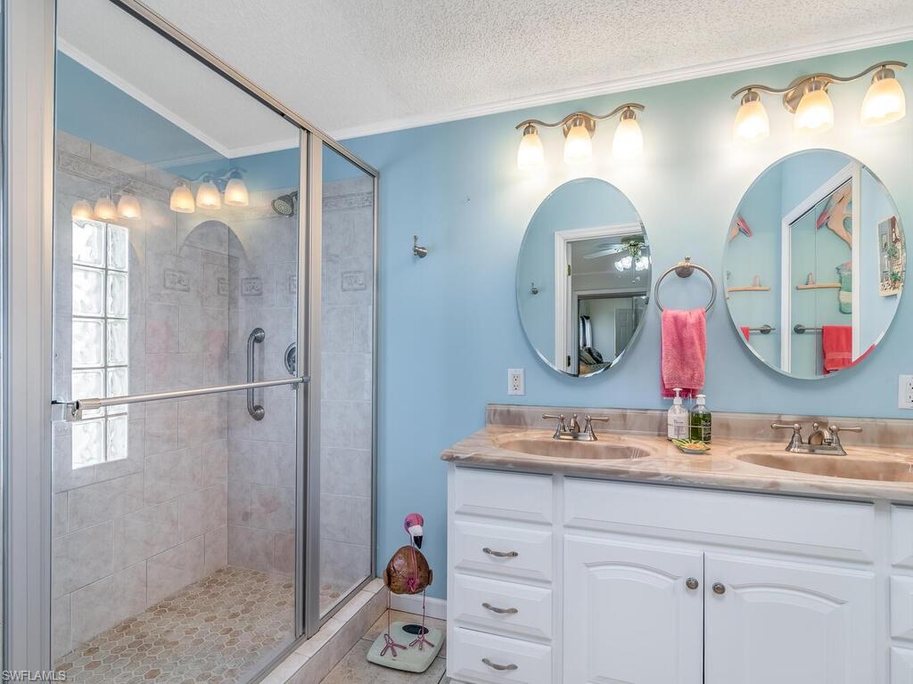 114 Audubon Road Naples, FL 34114 - Photo 17 of 34 a bathroom with a double vanity sink mirror and double