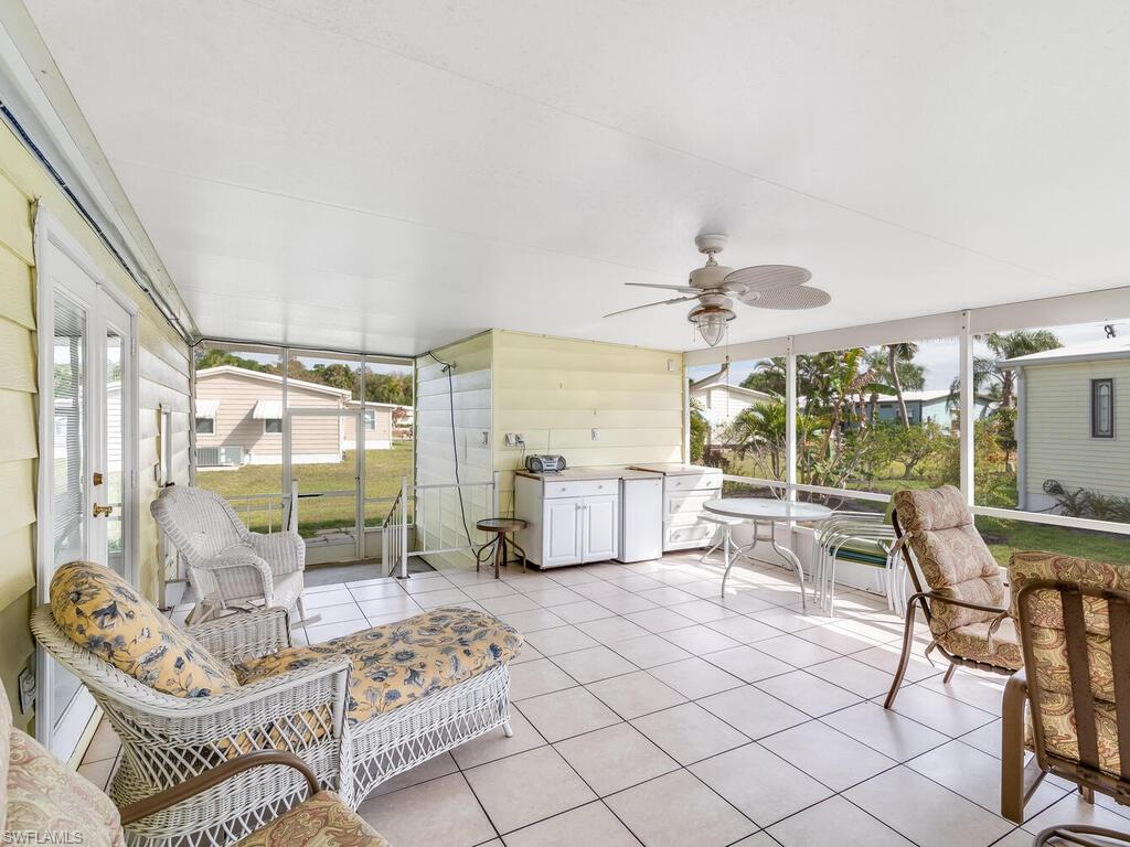 114 Audubon Road Naples, FL 34114 - Photo 2 of 34 a living room with furniture and a floor to ceiling window