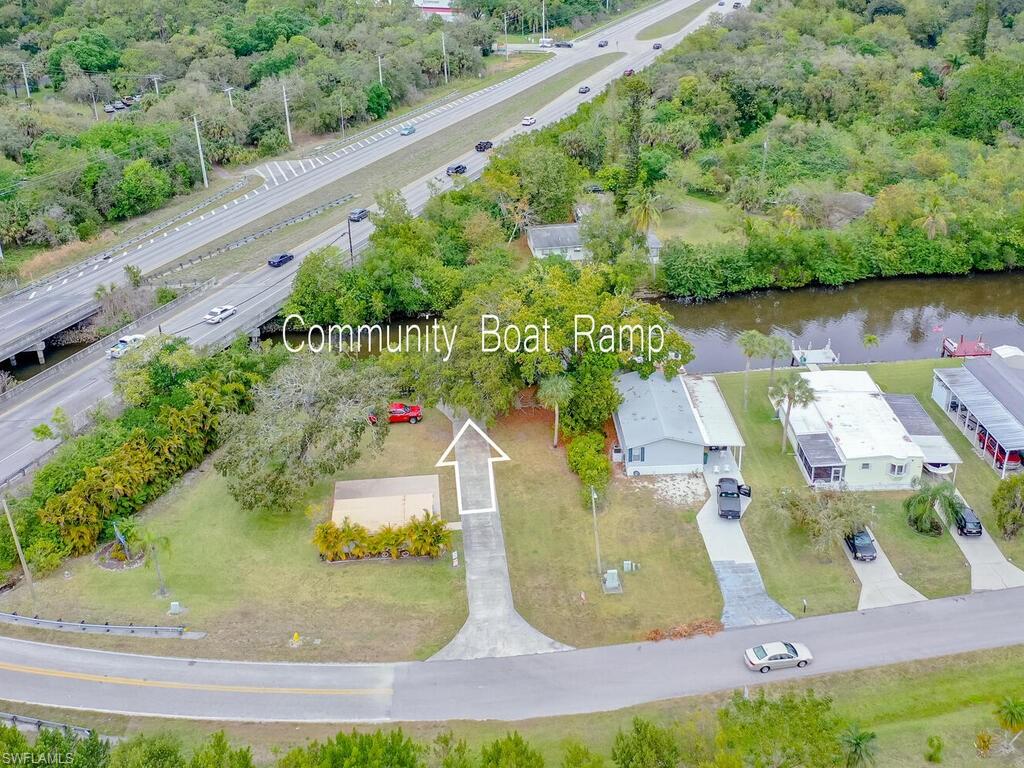 114 Audubon Road Naples, FL 34114 - Photo 26 of 34 an aerial view of a house with a yard and lake view