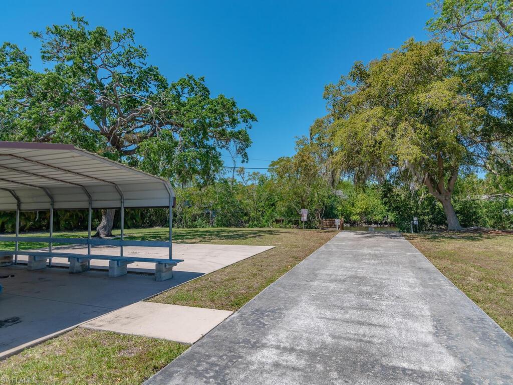114 Audubon Road Naples, FL 34114 - Photo 32 of 34 a view of a yard with plants and trees