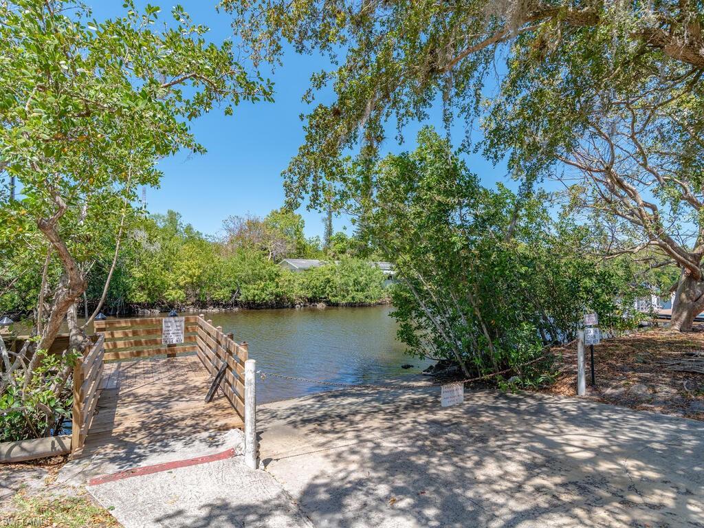 114 Audubon Road Naples, FL 34114 - Photo 33 of 34 a view of a lake with a large trees