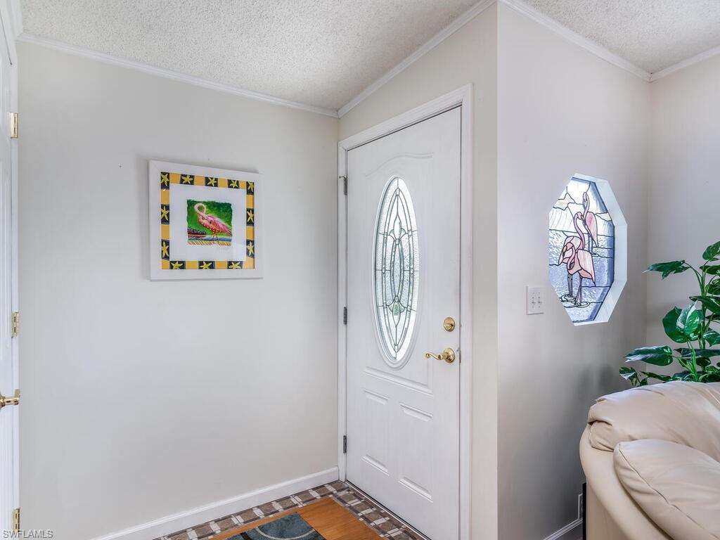 114 Audubon Road Naples, FL 34114 - Photo 5 of 34 a view of entryway with paintings on the wall