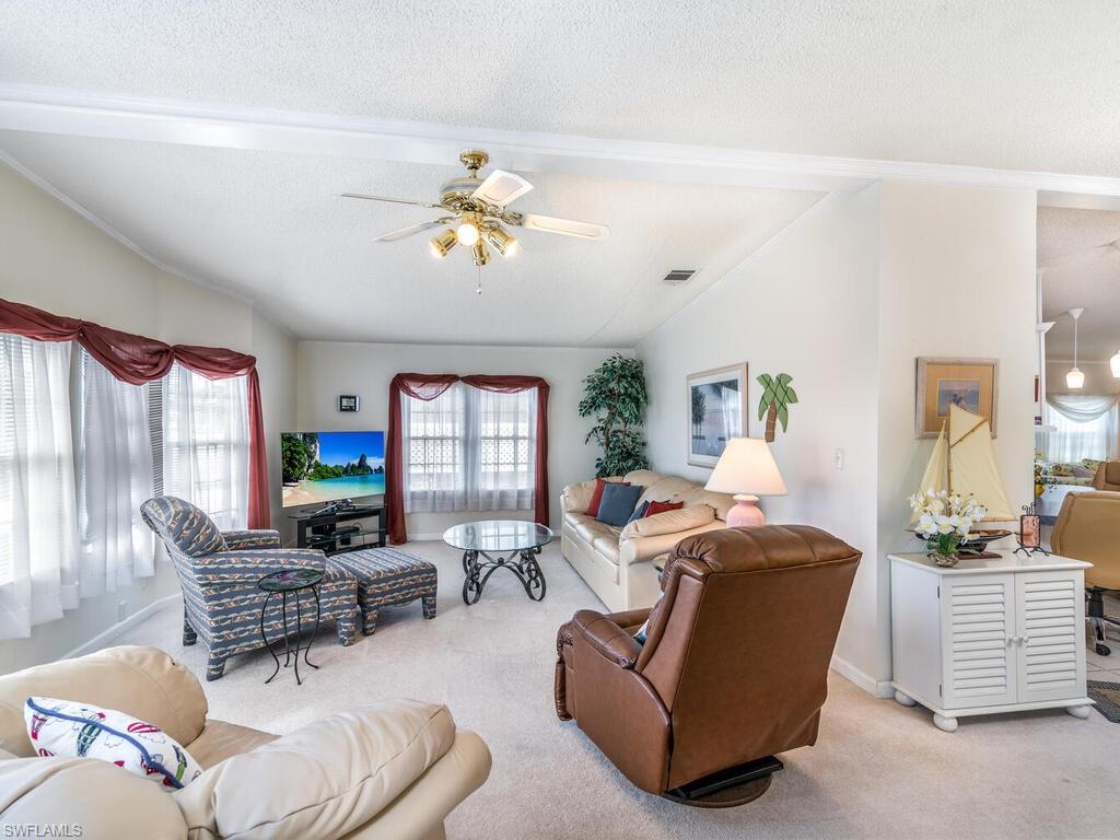 114 Audubon Road Naples, FL 34114 - Photo 6 of 34 a living room with furniture and a flat screen tv