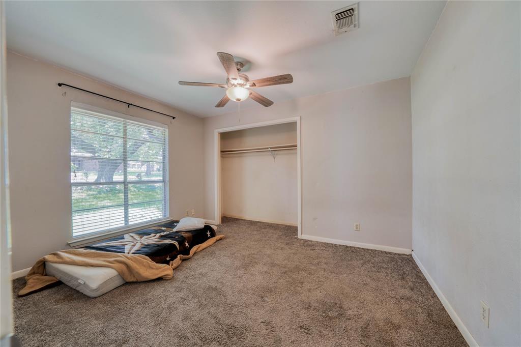 1006 Rikkity Lane Mount Pleasant, TX 75455 - Photo 23 of 39 an empty room with windows and ceiling fan