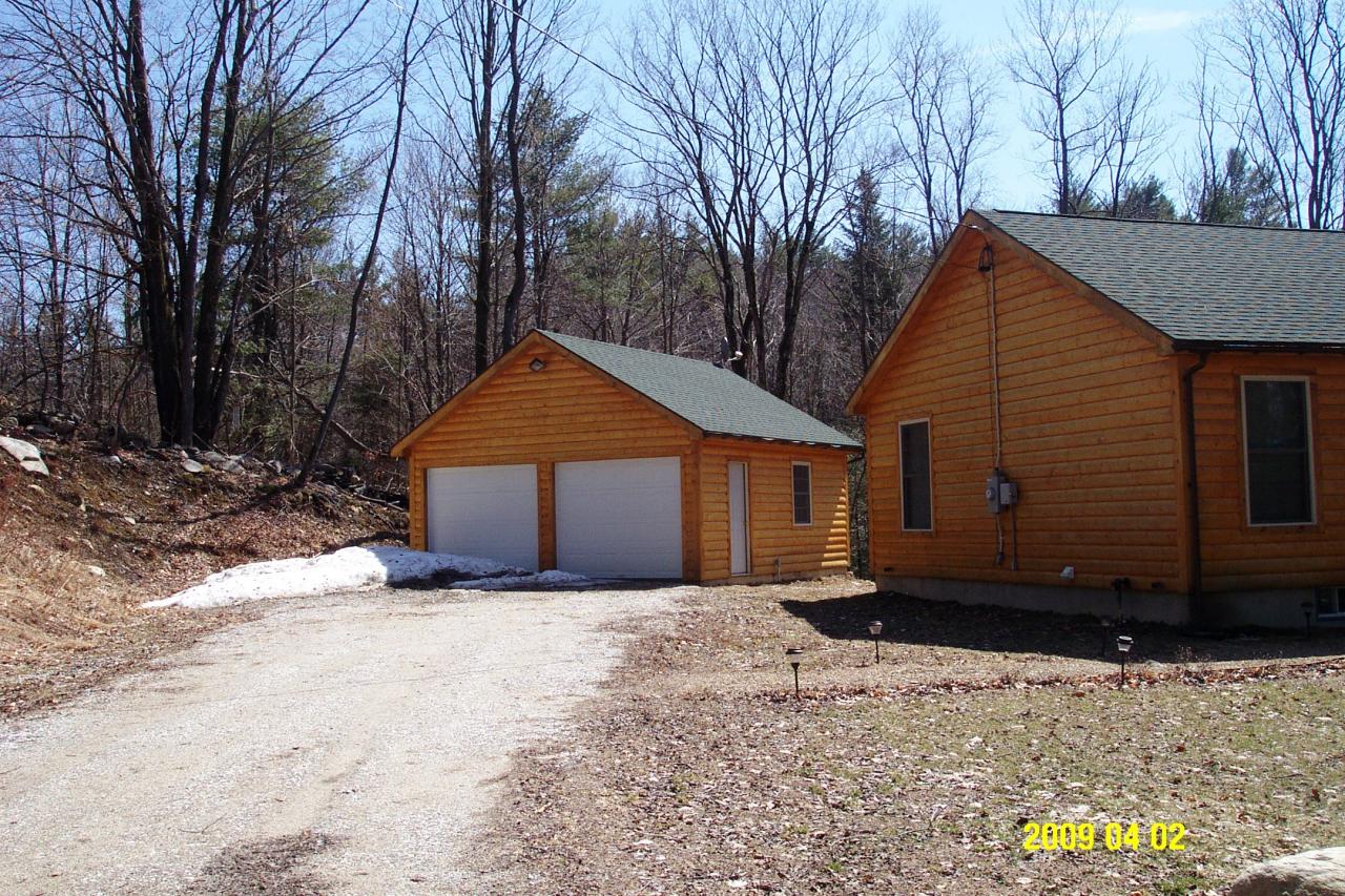 10 Calvin Road Hinsdale, MA 01235 - Photo 6 of 18 a front view of a house with a yard and garage