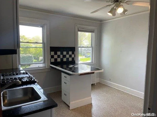 a kitchen with a sink and a stove