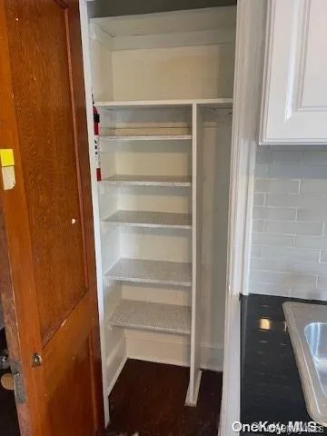 a view of walk in closet with empty racks