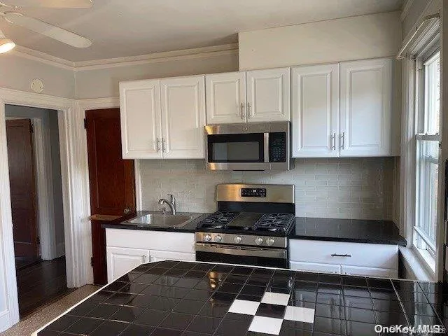 a kitchen with stainless steel appliances granite countertop a refrigerator and a stove top oven