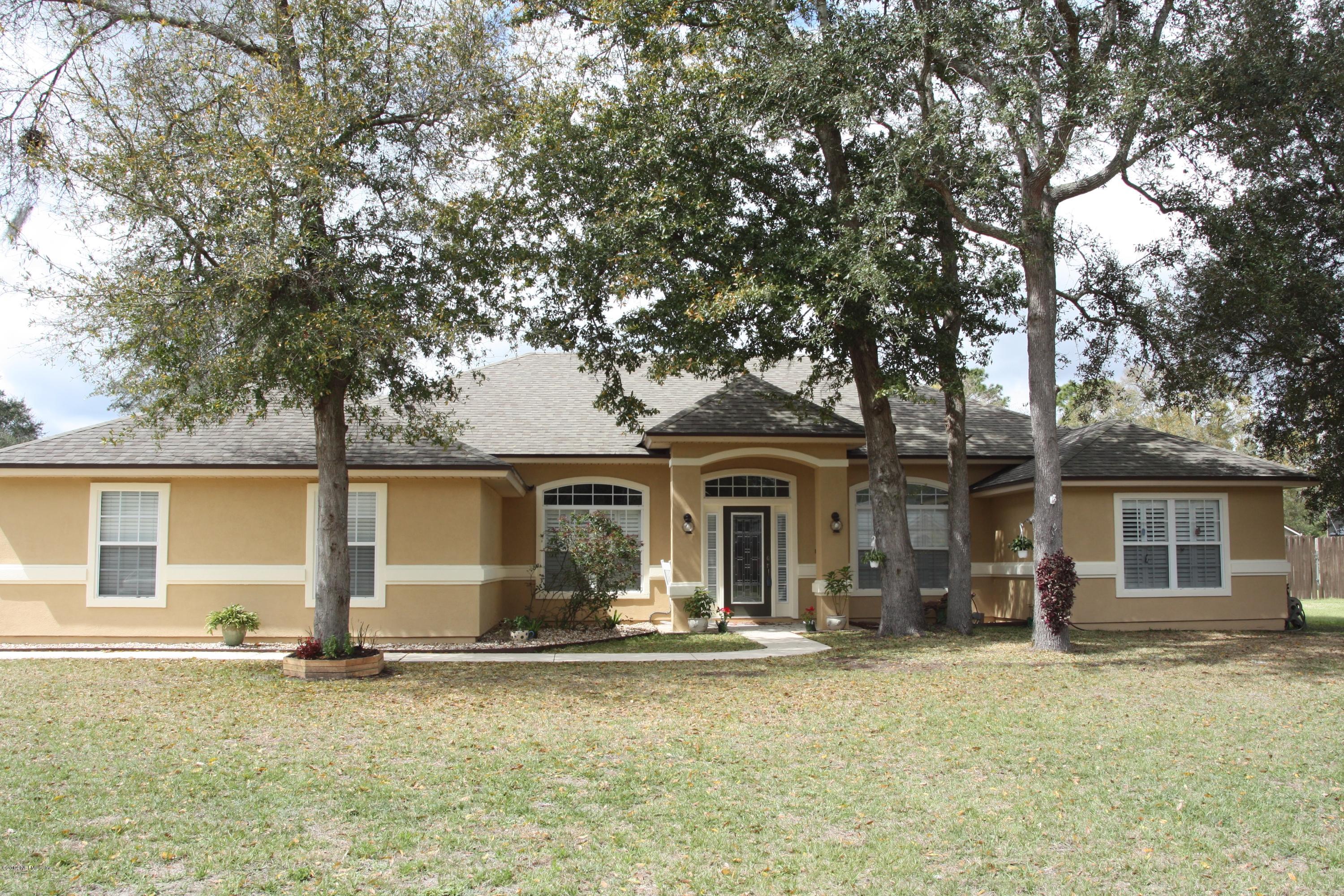 97178 Castle Ridge Drive Yulee, FL 32097 - Photo 1 of 14 front view of a house with a big yard