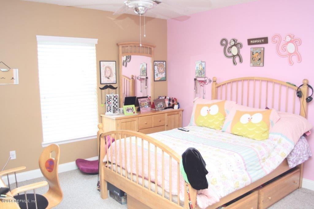 97178 Castle Ridge Drive Yulee, FL 32097 - Photo 11 of 14 a bedroom with a bed and a window