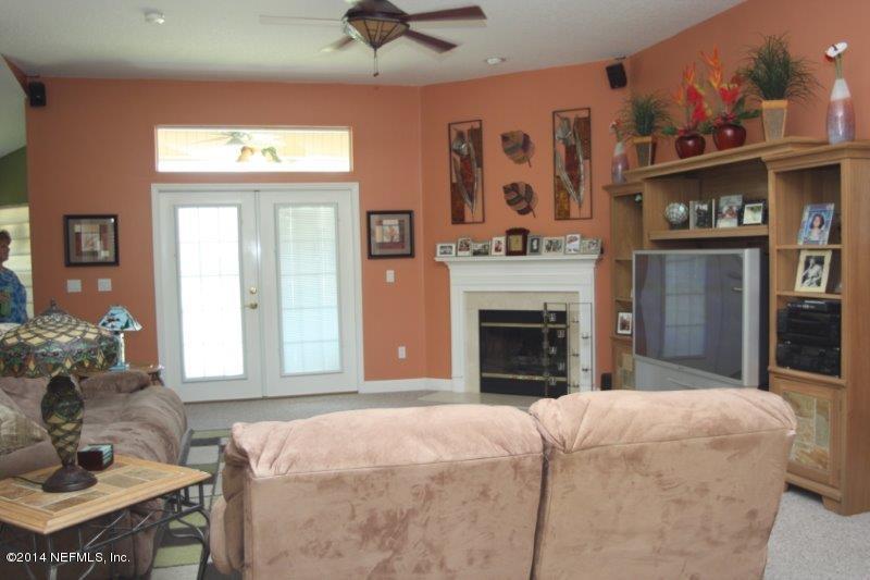 97178 Castle Ridge Drive Yulee, FL 32097 - Photo 2 of 14 a bed room with a bed and a fireplace