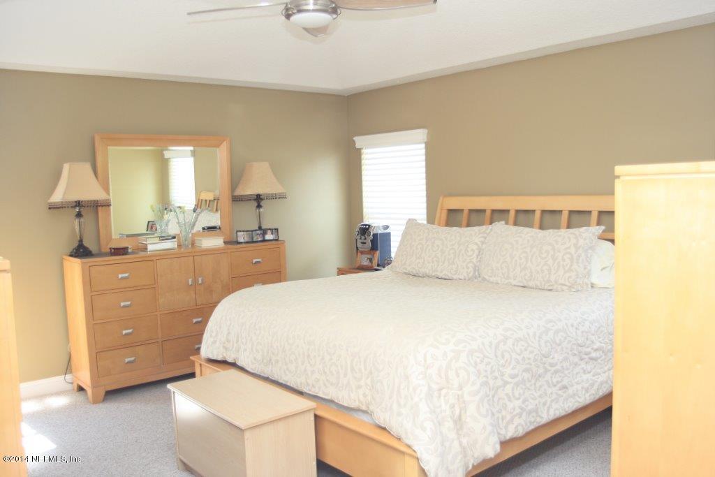 97178 Castle Ridge Drive Yulee, FL 32097 - Photo 8 of 14 a spacious bedroom with a bed and window