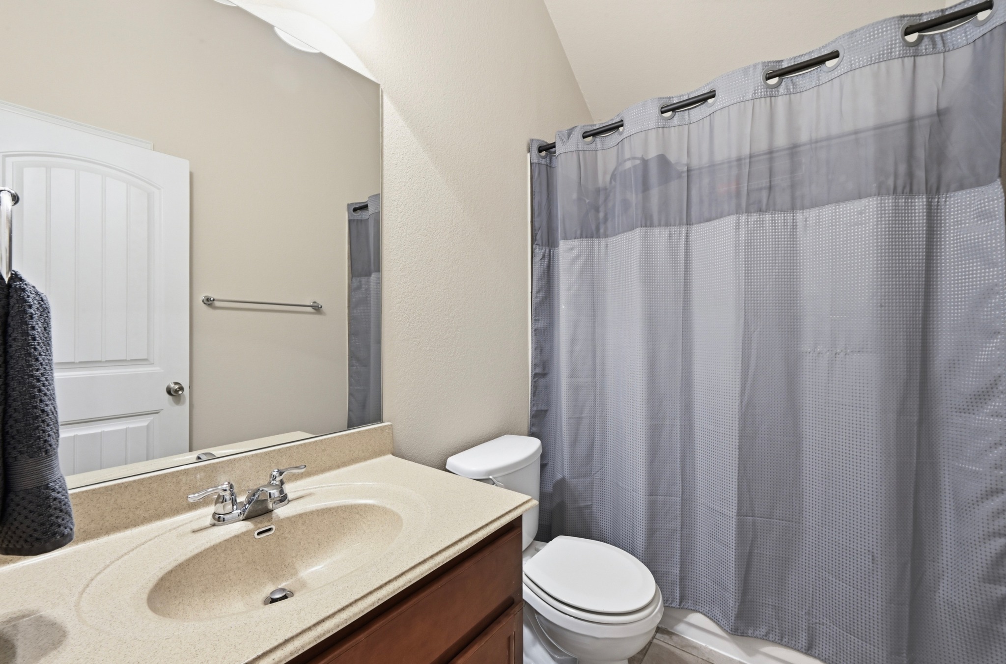 877 Hot Spring Valley Buda, TX 78610 - Photo 22 of 36 a bathroom with a sink a toilet a mirror and shower curtain