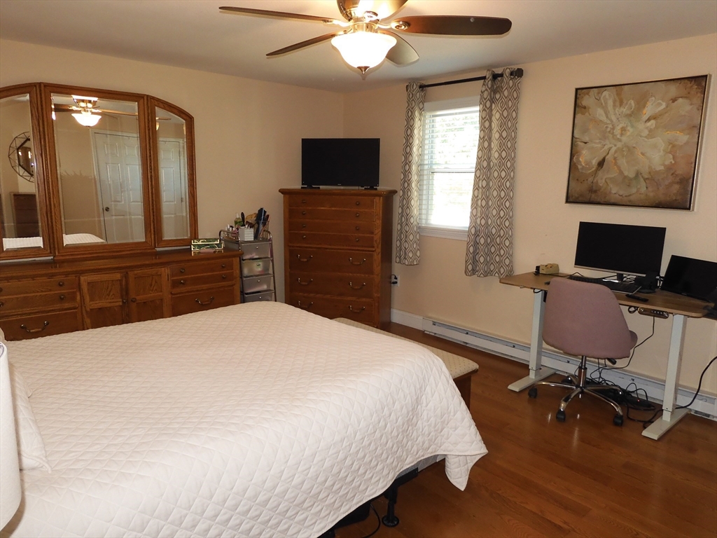 134 Old Ferry Road, Unit A Haverhill, MA 01830 - Photo 12 of 24 a bedroom with a bed and a flat screen tv