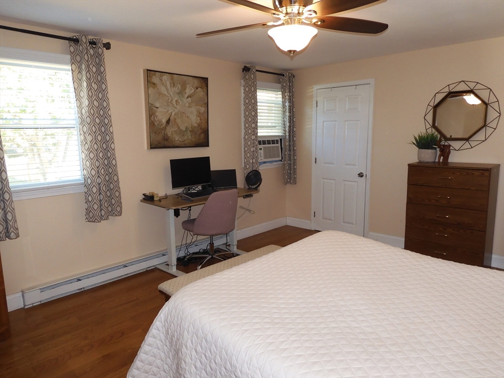 134 Old Ferry Road, Unit A Haverhill, MA 01830 - Photo 14 of 24 a bedroom with a bed a desk and chair