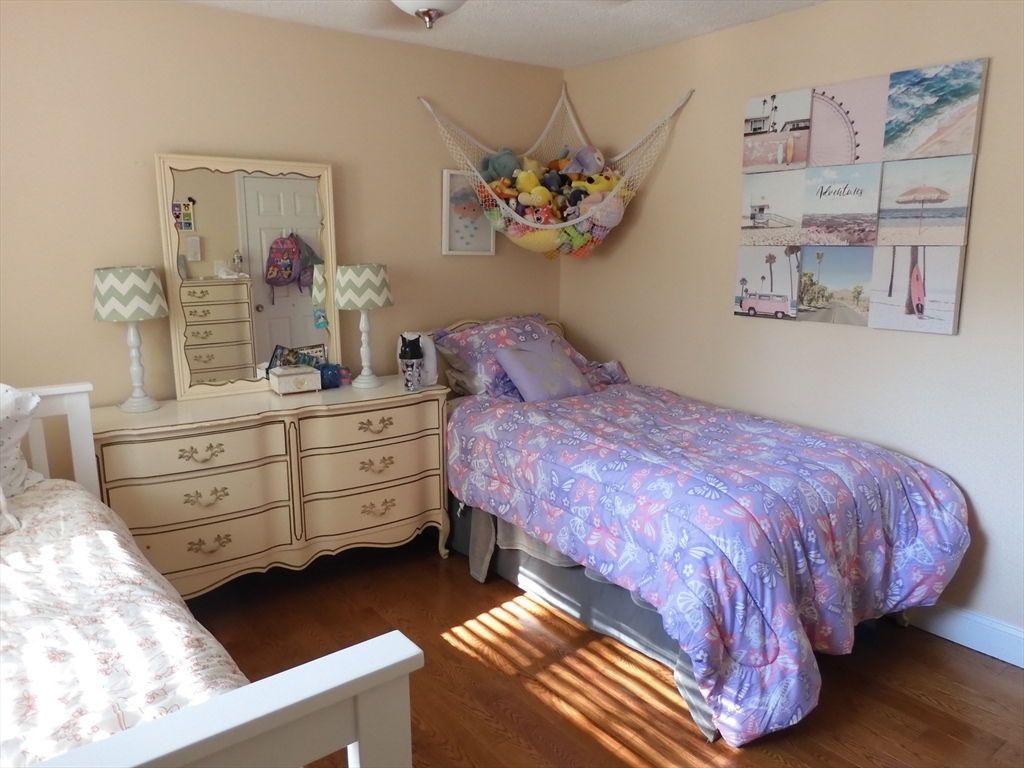 134 Old Ferry Road, Unit A Haverhill, MA 01830 - Photo 16 of 24 a bedroom with a bed and a chandelier
