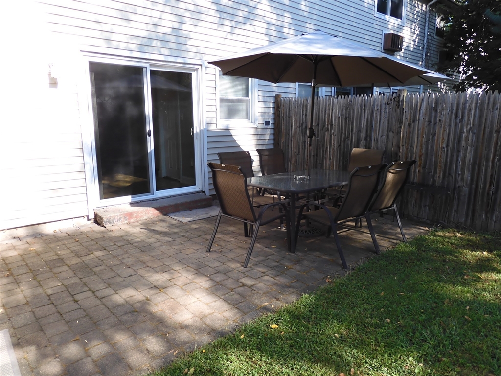 134 Old Ferry Road, Unit A Haverhill, MA 01830 - Photo 20 of 24 a view of backyard with table and chairs under an umbrella