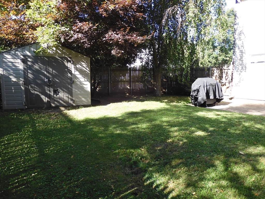 134 Old Ferry Road, Unit A Haverhill, MA 01830 - Photo 22 of 24 a view of a backyard with wooden fence and a bench