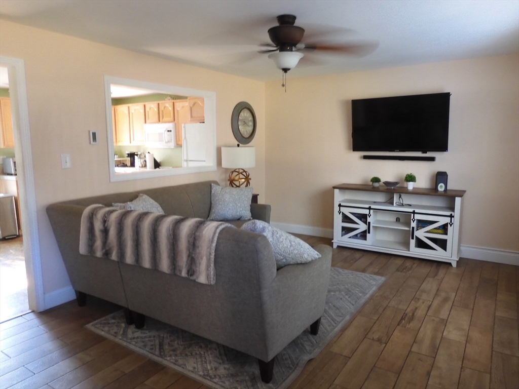 134 Old Ferry Road, Unit A Haverhill, MA 01830 - Photo 3 of 24 a spacious bedroom with a bed and a flat screen tv