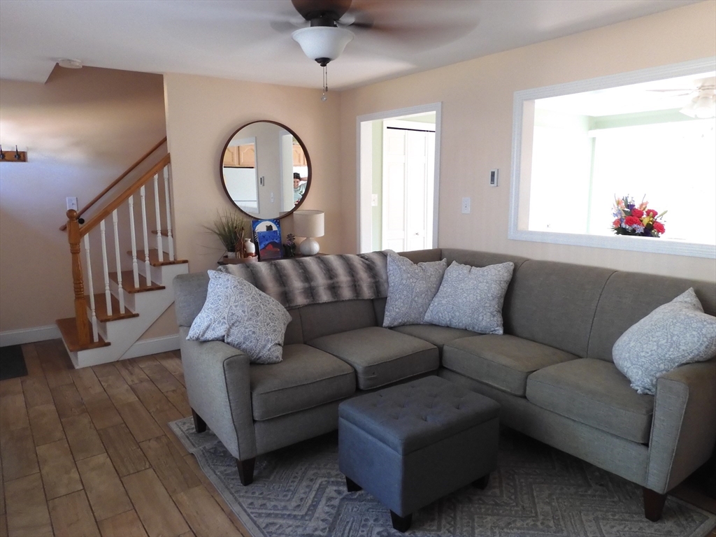 134 Old Ferry Road, Unit A Haverhill, MA 01830 - Photo 5 of 24 a living room with a couch and a mirror