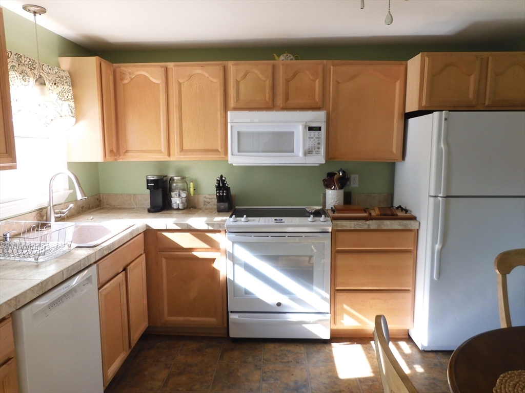 134 Old Ferry Road, Unit A Haverhill, MA 01830 - Photo 6 of 24 a kitchen with a refrigerator and a sink