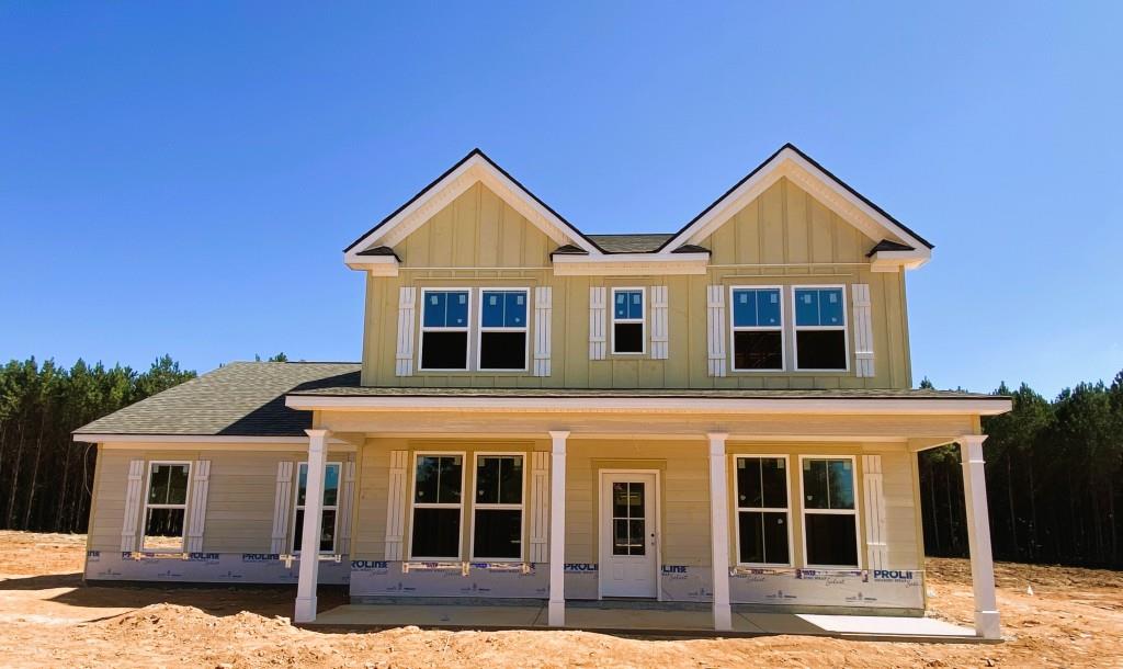 815 Cattle Barn Road Monroe, GA 30656 - Photo 1 of 1 a view of a white house with large windows