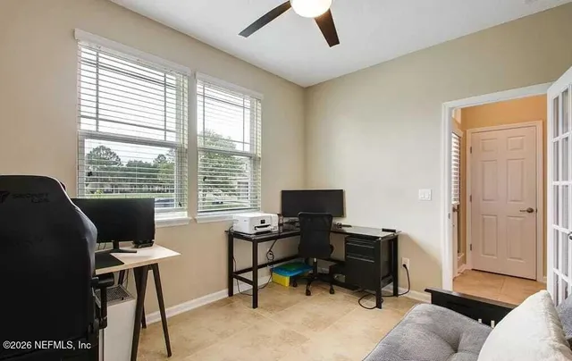 a livingroom with workspace and a window