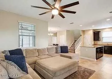 a living room with furniture and kitchen view