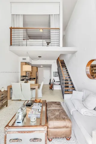 a view of kitchen and living room with wooden floor