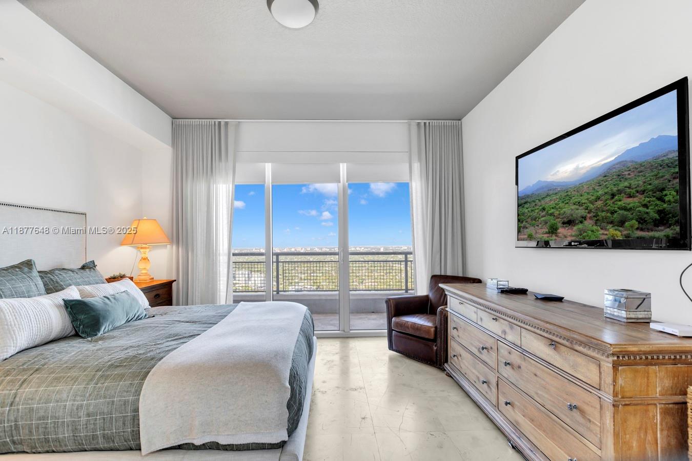 60 Southwest 13th Street, Unit 3402 Miami, FL 33130 - Photo 18 of 29 a bedroom with a large bed and a flat tv screen on dresser