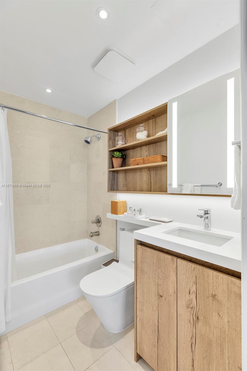 60 Southwest 13th Street, Unit 3402 Miami, FL 33130 - Photo 19 of 29 a bathroom with a sink a toilet and shower