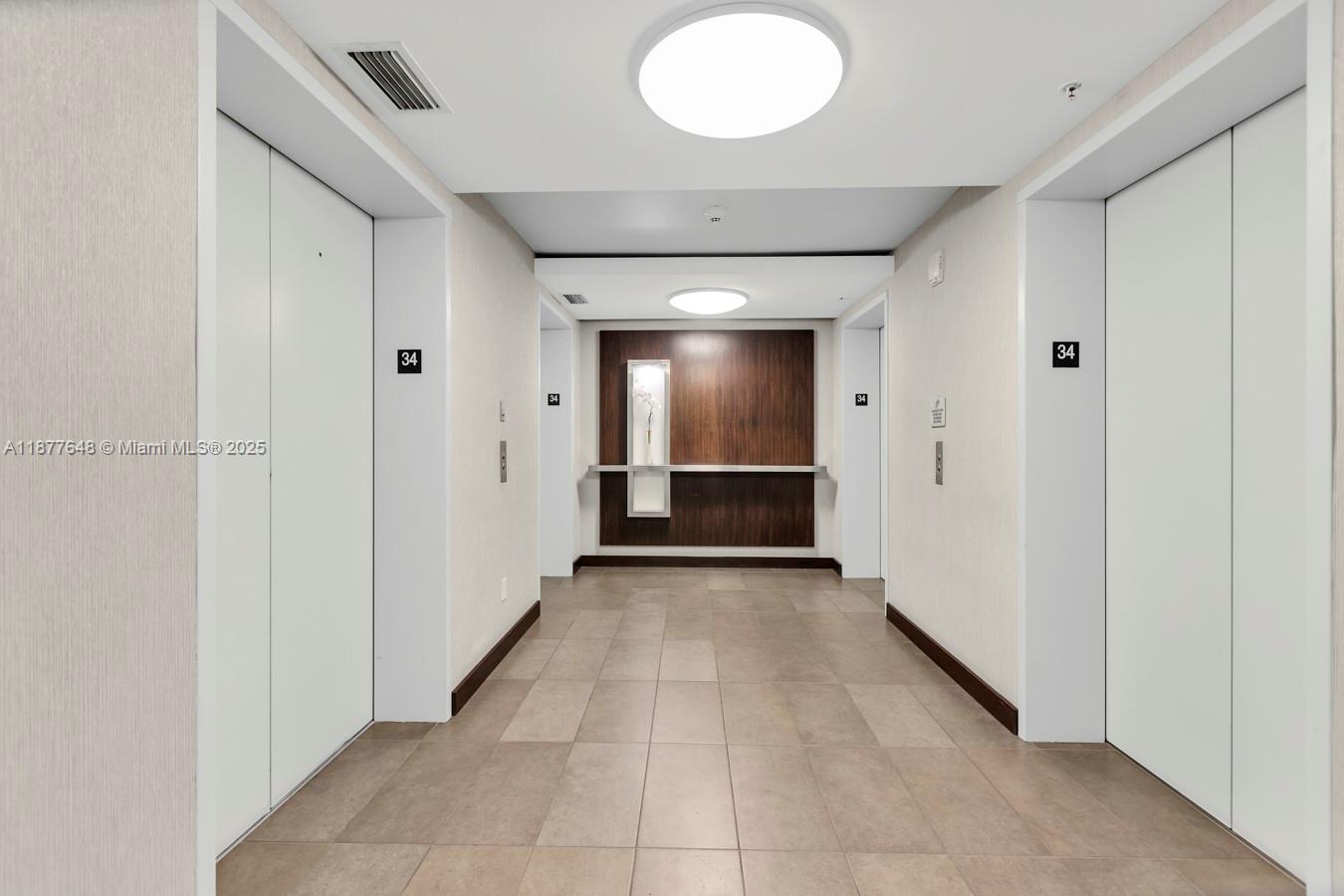 60 Southwest 13th Street, Unit 3402 Miami, FL 33130 - Photo 23 of 29 a view of a hallway with wooden shelves