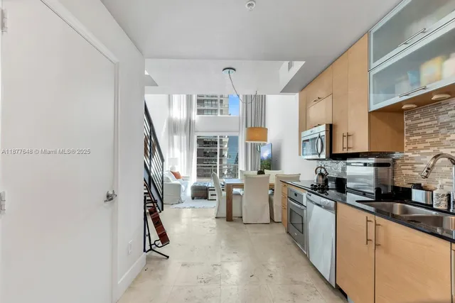 a kitchen that has a lot of cabinets and refrigerator