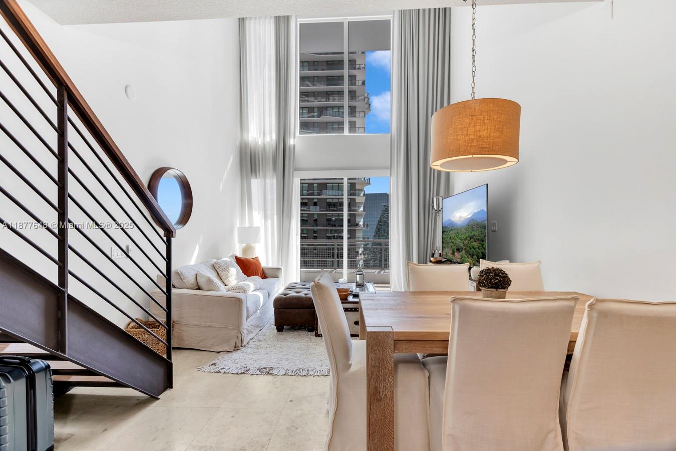 60 Southwest 13th Street, Unit 3402 Miami, FL 33130 - Photo 7 of 29 a living room with furniture and a window