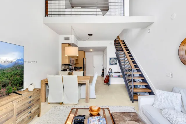 a living room with furniture and a piano