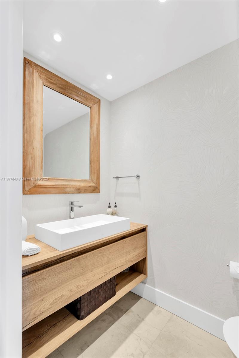 60 Southwest 13th Street, Unit 3402 Miami, FL 33130 - Photo 10 of 29 a bathroom with a sink and a mirror