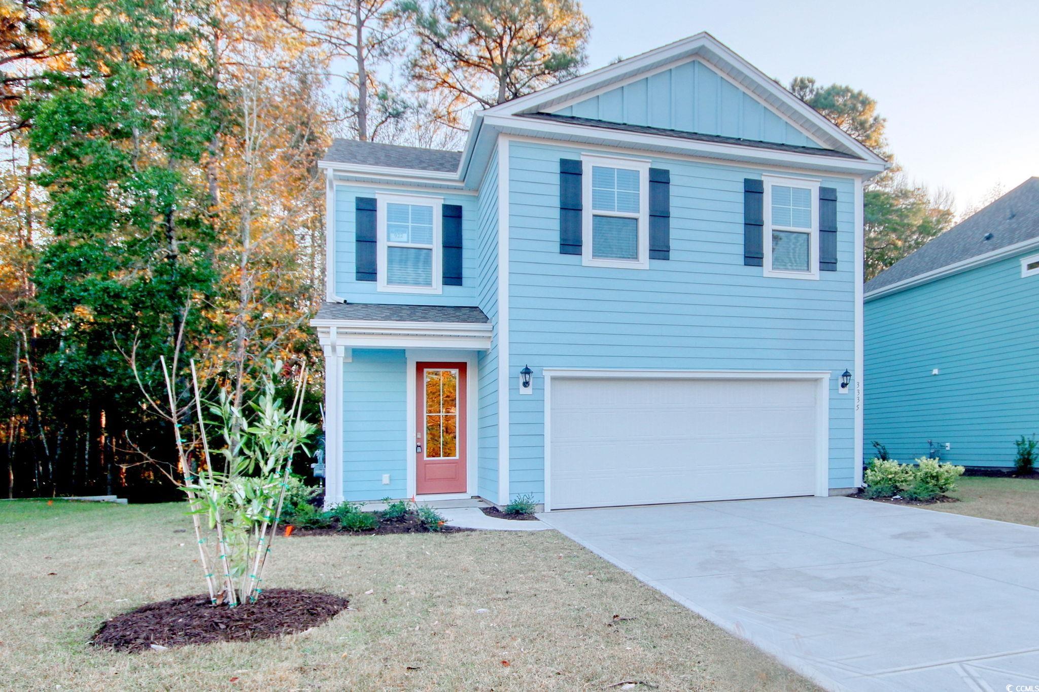 3335 Moss Bridge Lane Myrtle Beach, SC 29579 - Photo 2 of 31 View of front of house with driveway, board and batten siding, an attached garage, and a front lawn