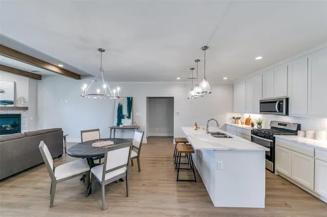 a view of a dining room with furniture and chandelier