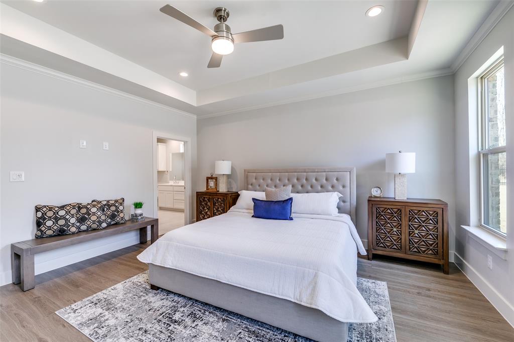 635 Community Lane Rockwall, TX 75087 - Photo 18 of 25 a bedroom with a large bed and a couch