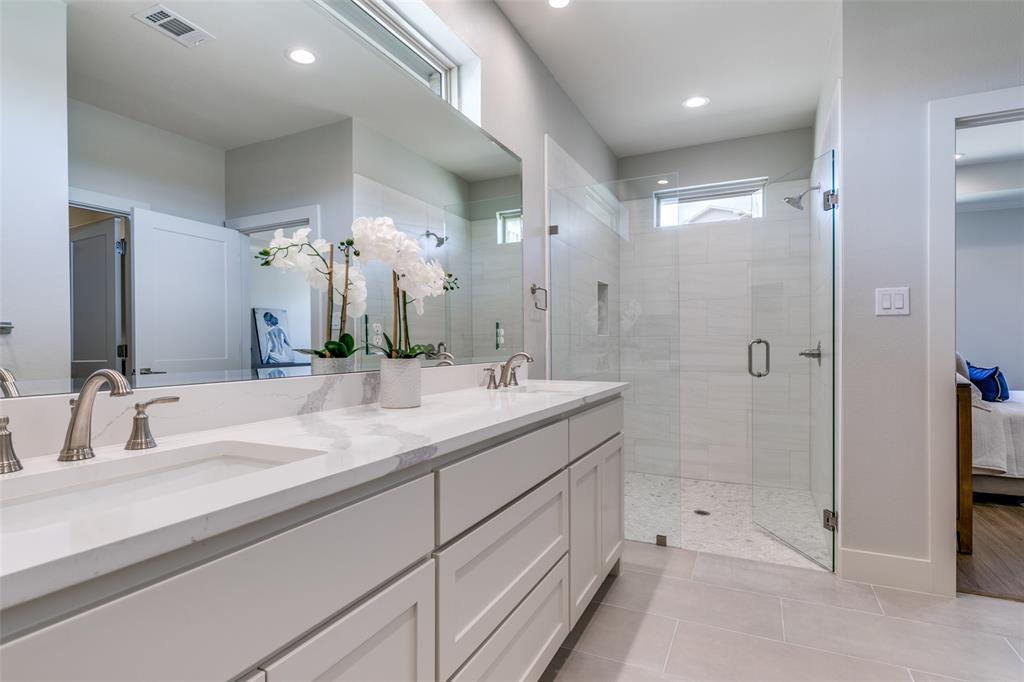 635 Community Lane Rockwall, TX 75087 - Photo 19 of 25 a bathroom with a shower sink and mirror