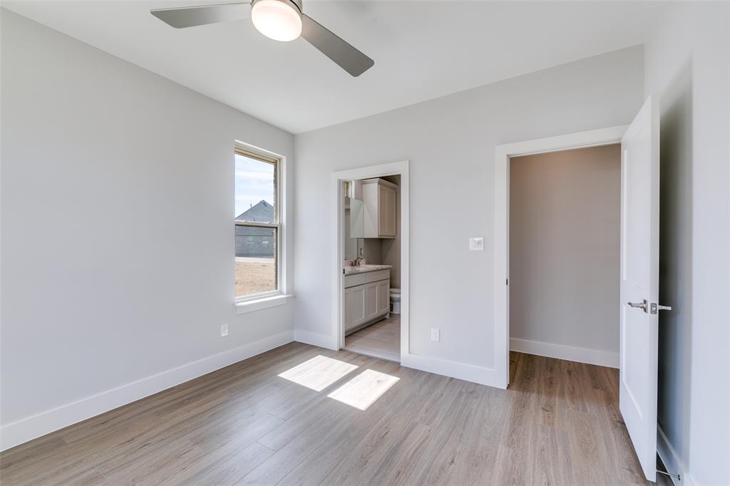 635 Community Lane Rockwall, TX 75087 - Photo 20 of 25 an empty room with wooden floor and windows