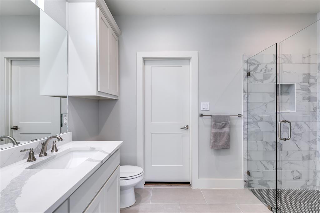 635 Community Lane Rockwall, TX 75087 - Photo 21 of 25 a bathroom with a sink toilet and shower